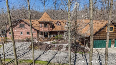 Welcome to this picturesque riverside estate nestled along the tranquil banks of South Haven's Black River, on 23 wooded acres. Recently remodeled to perfection, this enchanting property includes a main home, two adjacent guest apartments, and a spac...