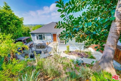 This beautifully redone contemporary home has incredible views, 20-foot cathedral ceilings and tons of natural light. The open floor plan is perfect for entertaining and features 4 bedrooms in the main house, plus a 372 square foot separate guest sui...