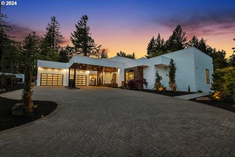 Indulge in the epitome of modern luxury at 11555 SE Hilltop Ct, Happy Valley, Oregon. This contemporary masterpiece, nestled on 2.18 lush acres, offers unparalleled sophistication and breathtaking scenery, a true sanctuary for discerning buyers.With ...