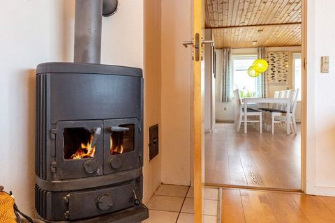 This cottage is located on a dune plot with panoramic views of the North Sea. In the well-appointed kitchen there is a dining area and access to the living room, where the wood stove is lit up for cosiness. From the living room there is access to a l...