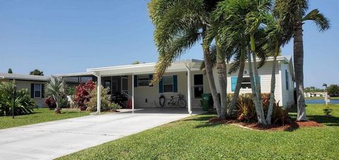 Experience the epitome of coastal living in this meticulously designed lakefront mobile home nestled in an active 55+ community residents have ample opportunities for recreation/social engagement.The 1900 sq ft. interior offers a wealth of modern fea...