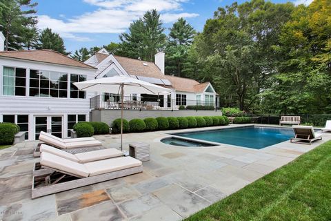 Architecturally striking Postmodern home with seven thousand square-feet of updated spaces and serene vistas across a four-acre property with sweeping velvety lawns and a private pond. Light-filled foyer leads to a step-down living room with a firepl...