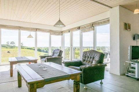 Large, spacious holiday cottage built in 2007 on an elevated plot in peaceful, scenic surroundings with 120 degree panoramic view over the Limfjord and the beautiful surroundings of the area. The house is modern and tastefully decorated in rlight, Da...