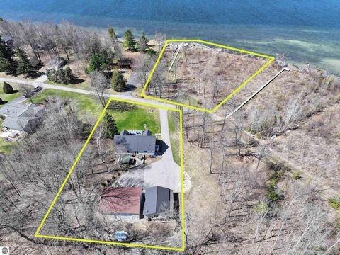 Opportunity awaits to own 300 Feet on the sought after sunset side of South Lake Leelanau's beautiful shoreline! This offering includes two parcels consisting of a waterfront vacant property with 300 ft. of frontage, 2.01 acres and a building envelop...