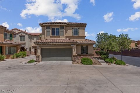 Terrific 3 Bedroom Home in Mountains Edge Featuring Tile flooring downstairs, Open Floorplan with plenty of windows for natural light, Upgraded cabinets, all appliances included, Corian Counters, Large Bedrooms, Desert Landscaping. Gated community wi...