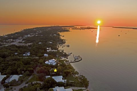 Prime location! Rare bayfront property in a private gated community located in the heart of downtown Islamorada with gorgeous sunset views, private pool and dockage! This original 4 bed/4 bath concrete home has a concrete roof and is ready for you to...