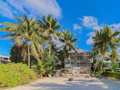 Welcome to your own slice of paradise in the Florida Keys. As you enter through this gated property, you'll find this truly one- of-a-kind 3 story, 3 bedroom, 3 bath, all concrete contemporary home on one of the most gorgeous private white sandy beac...