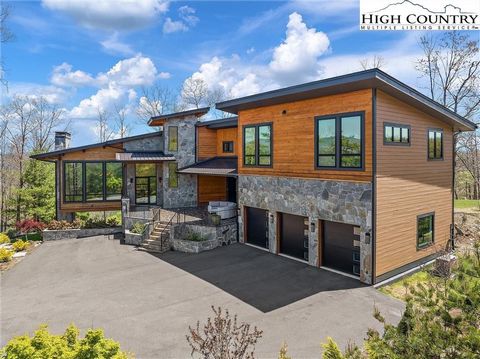 This stunning three level, timber frame, modern mountain home in Blue Ridge Mountain Club will take your breath away! This beauty sits on a knoll with over 3.6 acres where you can enjoy sunrise and sunset views from the dramatic walls of glass in the...