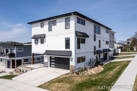 Fabulous newly constructed condominium in the heart of Grand Haven just one block up from the channel offers sweeping views and maintenance free living! Sunlight floods through the expansive windows allowing natural light to fill the spacious and ope...