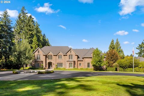 Gated estate in the Wilsonville countryside with over 4 acres of land complete with a guest house, 7 garages (3 attached oversized and 4 detached currently in use as an epic home gym with sauna), and a 4,600+ sq. foot indoor athletic training ground....