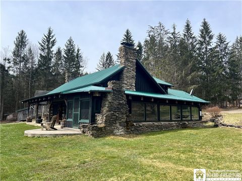 LOG CABIN ON 103 ACRES WITH 4 PONDS, 3 BARNS, CHICKEN COOP, TWO STORY GARAGE. Peaceful, serene, secluded setting. Two story entry has art gallery and leads to large great room w/rustic beams, creek stone fireplace, open staircase with custom steel ra...