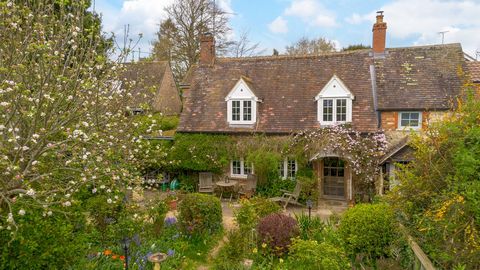 Manor Cottage is tucked away behind a beautiful stone wall just a short stroll from everything the village has to offer. This two-bedroom cottage is picture-perfect, hidden from view, bursting with character and with the most delightful garden. As yo...