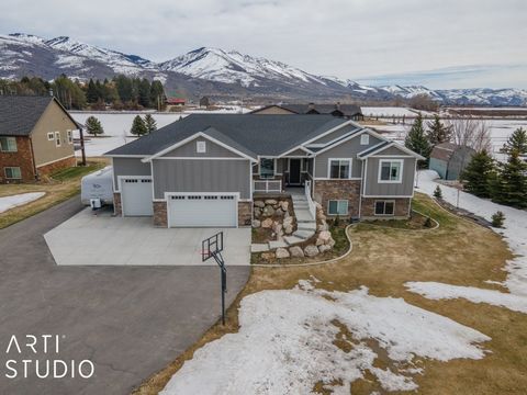 Nestled on an expansive lot in the serene mountains, this immaculate home boasts a custom gourmet kitchen, a fully finished basement with its own kitchen for added convenience, and a covered deck perfect for taking in the breathtaking mountain views ...