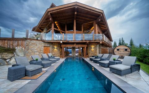 Every winter will turn into a wonderland from this spectacular lodge in the heart of the Alps. Against a backdrop of spectacular mountain ranges, take in 360-degree alpine views through the countless and expansive windows of this magnificent wooden a...