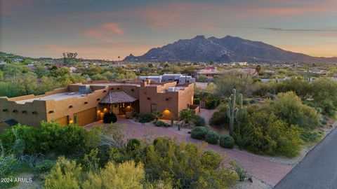 Experience resort-style living in this meticulously cared for custom-built home nestled on a large lot with breathtaking sunset and Black Mountain views. Step inside the Southwest inspired home to discover a seamless flow with Saltillo tile floors an...