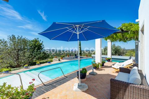 Detached house T4 with large land, in Loule. On the ground floor we find an entrance hall with tall windows, which gives you an immediate feeling of space. In the living room there is a corner with a wood-burning fireplace and its high-glazed windows...