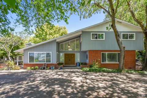 Step out your front door to views of the Berryessa Mountains, or unwind in the peaceful backyard surrounded by swaying Willow trees and a variety of fruit trees. This charming 4-bedroom mid-century modern country home is centered around a striking gl...