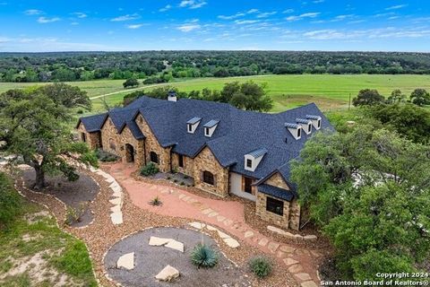 Luxury Hill Country Estate! This 35 +/- Ag exempt acreage offers an exquisite home w/3 bdrms, 3 full bthrms, & 2 half bths. The living area w/22 ft ceiling, kitchen complete w/top of the line appliances-wolf gas range & sub zero fridge, formal dining...