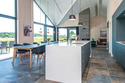 High-altitude holiday home in Sandersvig with a completely unique view of the Little Belt and life on the water. After a perhaps active day, you can relax in the outdoor and covered wellness area with jacuzzi, sauna and outdoor shower, where of cours...