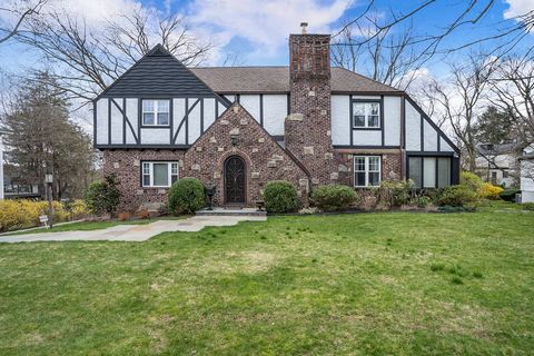 Stunning brick and stucco center hall Tudor drenched in an abundance of sunlight. The seamless flow features generous rooms throughout. Entry Hall leading to a large living room with fireplace and marble surround, French doors to family room/office w...