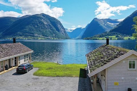 One of two beautiful holiday homes, located on the water's edge with beautiful views to high mountains and beautiful villages. Holiday home no. 06719 is seen from behind to the left towards the water. Live only 5 m from Jølstravatnet, Norway's most f...