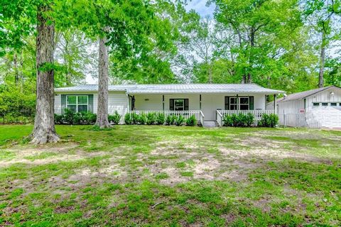 Experience the tranquility of country living in this charming home, boasting 3 bedrooms and 3 full bathrooms on nearly an acre lot enveloped by mature trees. Step onto the large front covered porch and immerse yourself in the serene surroundings. Ins...
