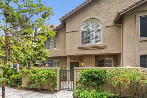 Enjoy living in one of the most appealing neighborhoods in Aliso Viejo. This peaceful, private townhome faces a greenbelt with abundant trees and has the added attraction of being an end unit with no one above or below. Relax on the fully enclosed sl...