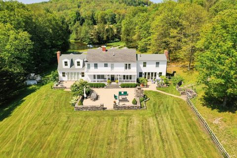 Fly into this private, hilltop country estate with its own airstrip. This five bedroom, five and one half bath home has stunning bucolic views to Stissing Mountain and provides a layout that has an airy and elegant ambiance. The cathedral living room...