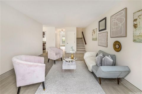 Welcome to this split-level townhome boasting two generously sized bedrooms, two full baths, and a host of desirable features. With expansive vaulted ceilings accentuating the spaciousness, beautiful tile flooring, and three lanais offering outdoor r...