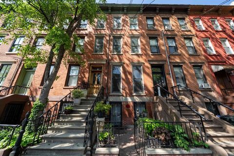 A truly one of a kind uniquely designed one family brick row home in the Historic Harsimus Cove downtown neighborhood. The home features four levels of unique charming details. Open chef kitchen includes eight burner stove, built in wall ovens, sub z...