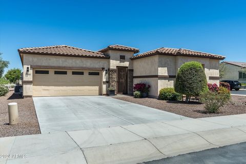 Huge $20K Price Reduction! Beautiful move-in ready, 3 bd/3 ba w/ casita, Mini-Estate w/ owned solar, 2164 total sq ft, nestled in the guard gated, 55Plus Active Adult lake community of CantaMia in Estrella Mtn Ranch. Premium lot. private paver courty...