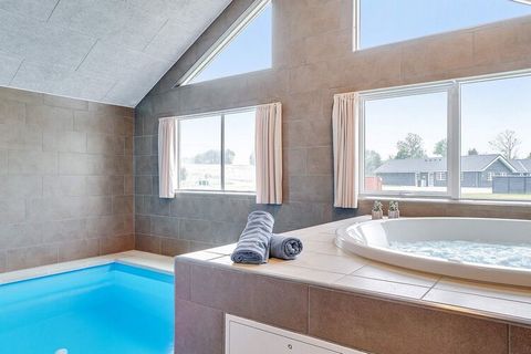 This well-appointed holiday cottage with swimming pool, whirlpool and sauna as well as various activities is located approx. 1200 m from the ocean at Grenå Strand. The pool area has a 20 m2 large swimming pool with water slide, counter-current system...