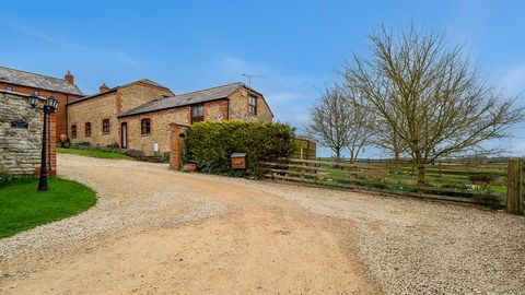 A beautifully presented barn conversion spanning to around 2,700 square feet with stunning countryside views, comprising cloakroom/WC, breakfast kitchen, utility room, three spacious reception rooms, four bedrooms, three bathrooms, triple garaging wi...
