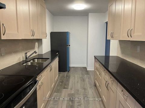 Recently Renovated, Spacious 3 Storey Stacked Townhouse. Large Kitchen with Quartz Counter top. Family Rm on Main Floor now self contained possible studio In-Law Apt. with separate entrance and walk out to patio and garden. Each floor has its own pri...