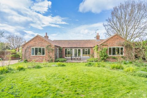 Located in a picturesque country village, this property offers a tranquil setting while being just 10 minutes from Aylsham. Constructed in 2004 in an American barn style, it includes approximately 3 acres of secluded paddocks and a stable, complement...