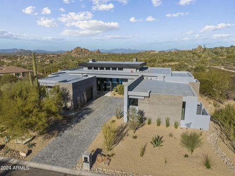 This contemporary masterpiece is located within the gated community of Troon Highlands Estates within Troon Village(Estimated completion date is mid-February). The private corner lot backs to HOA owned preserve featuring extensive views of the McDowe...