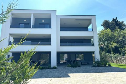 The island of Krk, Malinska, new apartment surface area 60,42 m2 for sale, on the ground floor of an urban villa with landscaped garden of 200 m2. The apartment consists of living room, kitchen, dining area, two bedrooms, bathroom, toilet, hallway an...
