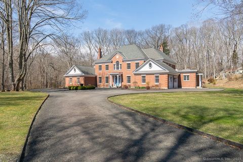 Come see this stately custom Brick English Georgian home in sought after Madison CT, nestled on a sprawling 5.65 acre lot with Neck River frontage. This exquisite 6,194 square foot colonial offers an unparalleled blend of luxury, privacy and natural ...
