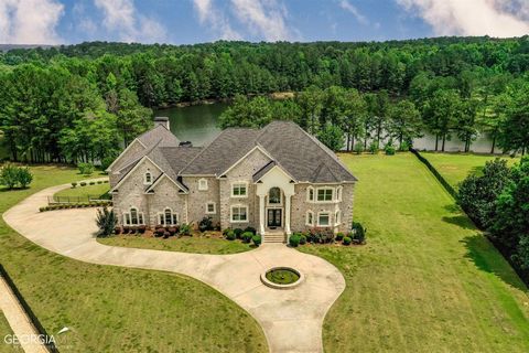 Sophisticated Elegance can be found in this Spectacular one-of-a-kind Loganville Estate. Conveniently located off 1-20, 35 mins from Downtown Atlanta. This impressive gated estate has 2.5 acres with breathtaking view of the lake. As you enter, you wi...