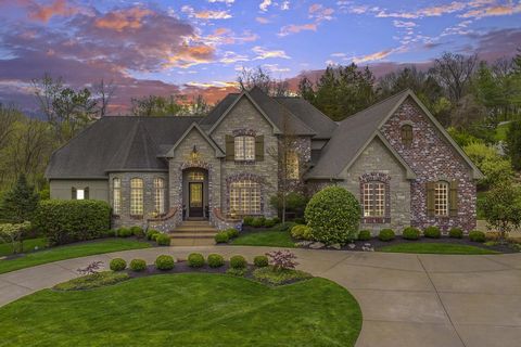 Exquisite 1.5-Story custom built home features over 6,400 square feet of living space (including covered patio with stone fireplace!) enhanced by exceptional craftsmanship and energy efficient systems throughout! Expansive hardwood Foyer opens to pri...