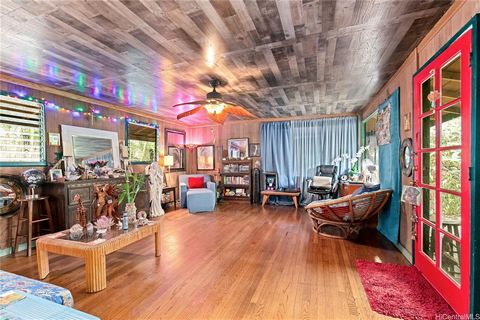 Welcome to Magical Makaha! Step into a verdant oasis boasting two charming homes nestled amidst fruit-bearing trees. The primary residence features original hardwood floors, offering 3 bedrooms and 2 bathrooms, while the second home provides 2 bedroo...
