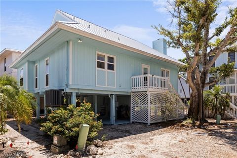 Welcome to a true rarity, a well designed 3 bedroom, 3 full bath Key West-style home located in the Sunset Captiva community. Cherished by a single owner since 1997, this home is tucked away on a quiet cul-de-sac and sheltered from storms and road no...