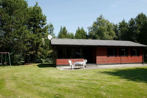 A holiday cottage with a simplistic style. The house is located on a natural plot with trees and bushes. Covered terrace and playground equipment.