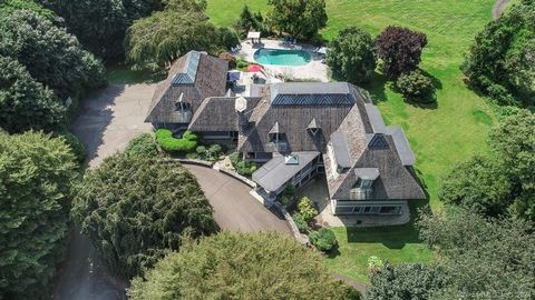 Escape to the privacy of this 7.65-acre Stoddard Hill Estate, a haven for enjoying breathtaking views of the Woodbridge countryside and Long Island Sound. Built in 2008 by the Garceau Brothers, this architect (Johnathan Isleb) designed home exudes qu...