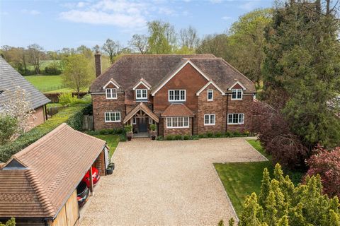 A magnificent residence boasting expansive accommodation of over 4,100 sq.ft across three floors, nestled on an exclusive private road and positioned within a southerly facing mature and private plot spanning approximately 1.8 acres. Woodpeckers exud...