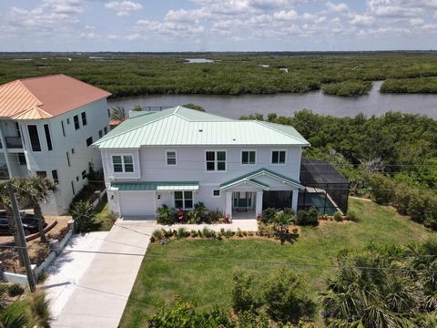 Experience the epitome of waterfront living in this stunning 3-bedroom home nestled in the sought-after no-drive Bethune Beach area of New Smyrna Beach. Boasting unparalleled riverfront views and just steps away from the pristine shores, this propert...