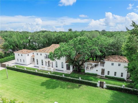 Step into the refined world of French architecture with this stunning Coral Gables home. You are welcomed by a grand foyer, modern double-sided fireplace, wood floors throughout, coffered ceilings and an elegant curved staircase. The spacious living ...