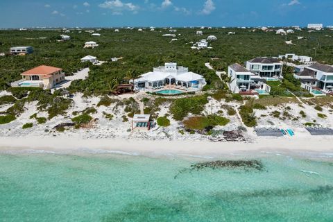 Conched Out Villa is a 7 bedroom, 8 bathroom luxury beachfront villa perfectly positioned on the private and stunning Long Bay Beach on the southeastern side of Providenciales. This grand villa welcomes one down the long lushly landscaped driveway gr...