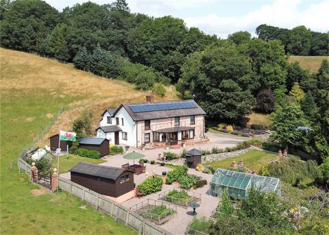 An impressive four-bedroom timber framed long house sitting in approximately one and a half acres of grounds including gardens, parking, wooded dingle, a variety of outbuildings and marvellous views over surrounding countryside. South facing elevatio...