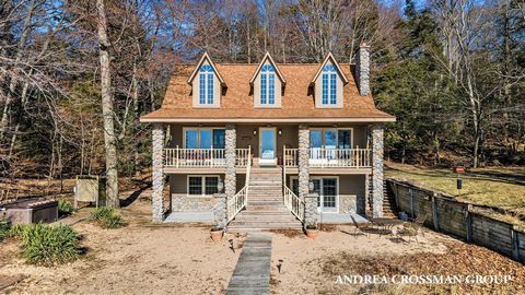 Immerse yourself in the tranquility of Michigan's beloved ''up north'' lifestyle at this extraordinary Lake Michigan waterfront home. With an impressive 240 feet of sandy, expansive beachfront, this property is a true gem. Located in the Little Point...